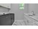 The laundry room features a washing machine, dryer, sink and marble floors at 3075 Jamestown Dr, Gastonia, NC 28054