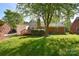 Spacious backyard with mature trees and a small deck at 317 Port Royal Dr, Matthews, NC 28105