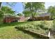 Expansive backyard featuring lush greenery and a detached garage at 317 Port Royal Dr, Matthews, NC 28105