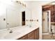 Well-lit bathroom featuring a double vanity, a large mirror, and a shower with glass doors, offering functionality and style at 317 Port Royal Dr, Matthews, NC 28105