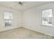 Sunny bedroom featuring two windows and neutral carpet, providing ample natural light and a cozy atmosphere at 317 Port Royal Dr, Matthews, NC 28105