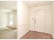 Inviting entryway featuring wood floors and a bright, neutral color palette at 317 Port Royal Dr, Matthews, NC 28105