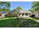 Charming brick home featuring a well-manicured lawn and mature trees at 317 Port Royal Dr, Matthews, NC 28105
