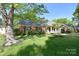 Traditional brick home with lush green lawn and mature shade trees at 317 Port Royal Dr, Matthews, NC 28105