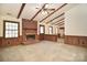 Cozy living room featuring wood paneling, fireplace, and beamed ceilings at 317 Port Royal Dr, Matthews, NC 28105