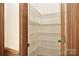 Pantry featuring shelving and wood trim around entry at 317 Port Royal Dr, Matthews, NC 28105