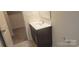 Modern bathroom featuring a sleek vanity with white countertop, mirror, and neutral tile floor at 3173 Pinehills Way, Mount Holly, NC 28120