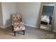 Neutral bedroom space with accent chair and a full-length mirrored closet door at 3173 Pinehills Way, Mount Holly, NC 28120