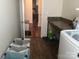 Bright laundry room features a countertop, storage, and wood flooring at 3173 Pinehills Way, Mount Holly, NC 28120