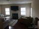 Living room with plush seating, fireplace, and abundant natural light at 3173 Pinehills Way, Mount Holly, NC 28120