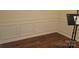 Room showcasing elegant wall paneling, hardwood floors, and a clean, modern design at 3173 Pinehills Way, Mount Holly, NC 28120