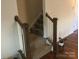 Carpeted staircase with wooden banister and natural light, leading to upper level at 3173 Pinehills Way, Mount Holly, NC 28120