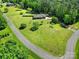 Aerial view of a well-maintained property with lush green lawns, mature trees, and a long driveway at 3270 Kings Row Dr, Rock Hill, SC 29732