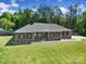 Charming brick home with a well-manicured lawn, classic shutters, and lovely landscaping at 3270 Kings Row Dr, Rock Hill, SC 29732