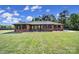 Well-maintained brick ranch-style home with a lush green lawn and mature trees at 3270 Kings Row Dr, Rock Hill, SC 29732