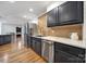 Modern kitchen with stainless steel appliances, stone countertops, and stylish dark cabinets at 3270 Kings Row Dr, Rock Hill, SC 29732