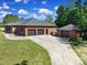 Rear exterior of brick home featuring a spacious three-car garage and well-manicured lawn at 3270 Kings Row Dr, Rock Hill, SC 29732