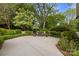 A cozy backyard seating area featuring a swing, lush greenery, and a well-manicured lawn at 3300 Sharon Rd, Charlotte, NC 28211