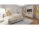 This bedroom features natural light, an elegant chandelier, and a view from the window at 3300 Sharon Rd, Charlotte, NC 28211