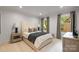 Comfortable bedroom featuring neutral tones, soft lighting, and a view from the window at 3300 Sharon Rd, Charlotte, NC 28211