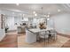 Open dining area showcasing modern lighting and a seamless flow to the kitchen at 3300 Sharon Rd, Charlotte, NC 28211