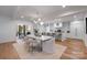 Stylish dining area with modern lighting, light neutral colors, and hardwood floors at 3300 Sharon Rd, Charlotte, NC 28211