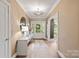 Inviting entryway featuring neutral colors, a decorative mirror, and ample lighting at 3300 Sharon Rd, Charlotte, NC 28211