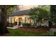 Inviting home exterior featuring manicured landscaping, stone steps, and a welcoming entrance at 3300 Sharon Rd, Charlotte, NC 28211