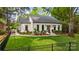 A well-kept home with manicured lawn, trimmed shrubs, and black framed windows adding a modern touch at 3300 Sharon Rd, Charlotte, NC 28211