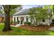 Charming white brick home featuring neat landscaping, a front garden, and a welcoming entrance at 3300 Sharon Rd, Charlotte, NC 28211