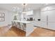 Bright kitchen features a large island with seating, pendant lighting, and stainless steel appliances at 3300 Sharon Rd, Charlotte, NC 28211
