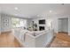 Open-concept living room with hardwood floors, a fireplace, and natural light at 3300 Sharon Rd, Charlotte, NC 28211