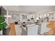Spacious living room showcasing neutral decor, hardwood floors, and seamless flow to kitchen at 3300 Sharon Rd, Charlotte, NC 28211