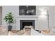 Cozy living room featuring a fireplace, mounted TV, and stylish decor at 3300 Sharon Rd, Charlotte, NC 28211