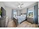 Comfortable bedroom with neutral walls, a ceiling fan, and natural light streaming through the windows at 360 N Broad St, Waxhaw, NC 28173