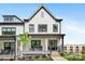 Charming white townhome with a covered front porch and landscaped yard, offering inviting curb appeal at 360 N Broad St, Waxhaw, NC 28173