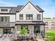 Charming white townhome with a covered front porch and landscaped yard, offering inviting curb appeal at 360 N Broad St, Waxhaw, NC 28173