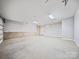 Spacious three-car garage with clean concrete floor and bright lighting and plenty of room for storage at 360 N Broad St, Waxhaw, NC 28173