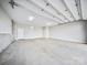 Spacious three-car garage with clean concrete floor and bright lighting and plenty of room for storage at 360 N Broad St, Waxhaw, NC 28173