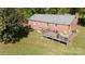 Aerial view of brick home with large backyard, wooden deck, and mature trees at 3842 Harmony Rd, Catawba, SC 29704