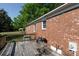 Wooden back deck perfect for outdoor entertaining, features table and grill setup at 3842 Harmony Rd, Catawba, SC 29704