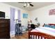 Cozy bedroom features wood floors, ceiling fan, and desk area for study or work at 3842 Harmony Rd, Catawba, SC 29704