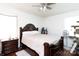 Comfortable bedroom with a dark wood frame bed, matching nightstand, and natural light at 3842 Harmony Rd, Catawba, SC 29704
