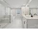Bright bathroom with marble tiled floors, double vanity, walk-in shower, and soaking tub at 404 Balboa St, Matthews, NC 28104