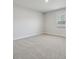 Neutral bedroom with carpet and lots of light from the large window at 404 Balboa St, Matthews, NC 28104