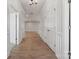 Bright hallway with hardwood floors, white trim, and doors leading to various rooms in the home at 404 Balboa St, Matthews, NC 28104