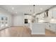 Modern kitchen with white cabinets, stainless steel appliances, and a large island with pendant lighting at 404 Balboa St, Matthews, NC 28104