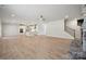 Expansive living room featuring hardwood floors and an open floor plan to kitchen with stainless steel appliances at 404 Balboa St, Matthews, NC 28104