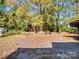 Large backyard with shade trees and a small outbuilding, perfect for outdoor activities at 412 Keels Ave, Rock Hill, SC 29730