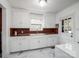 Bright kitchen with a farmhouse sink, white cabinets, and a window above sink at 412 Keels Ave, Rock Hill, SC 29730